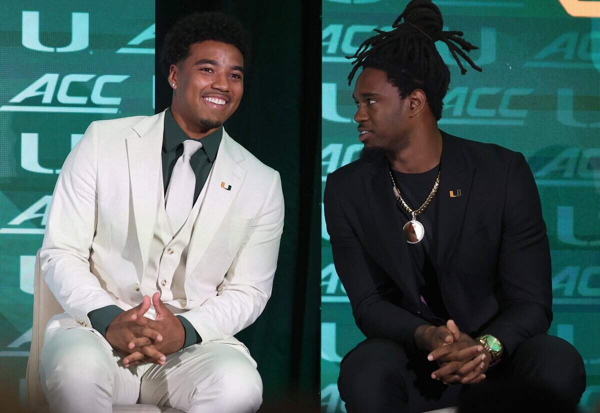 Miami Hurricanes quarterback Darian Mensah smiles as he listens to running back Mark Fletcher Jr., right, after speaking during the 2026 ACC Football Kickoff program at the Hilton Charlotte Uptown Hotel in Charlotte, NC on Wednesday, July 15, 2026.